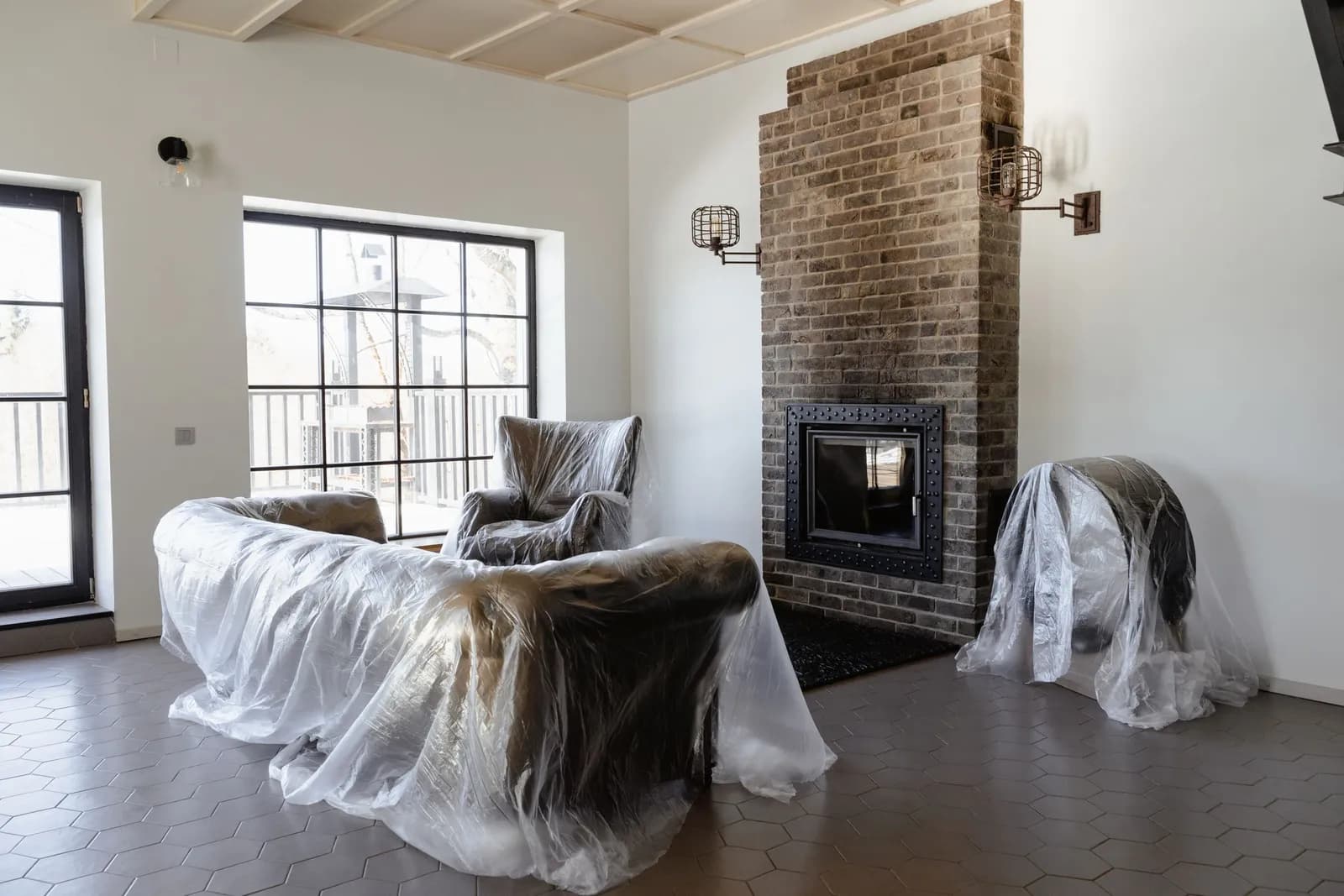 Furniture still wrapped in dust sheets in a newly renovated living room